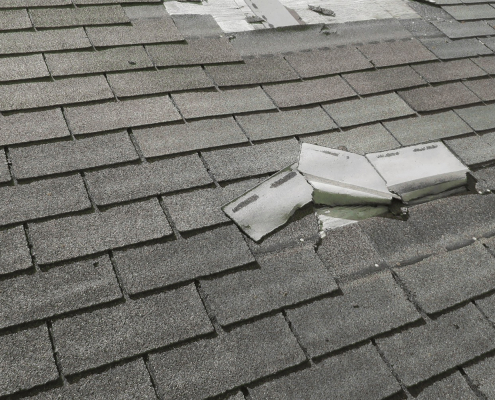 Illustration of a house with a damaged roof after a storm