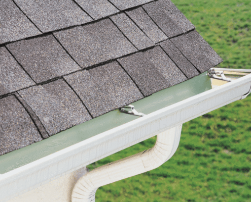 A drawing of gutter guards being installed on a house showcasing their benefits.