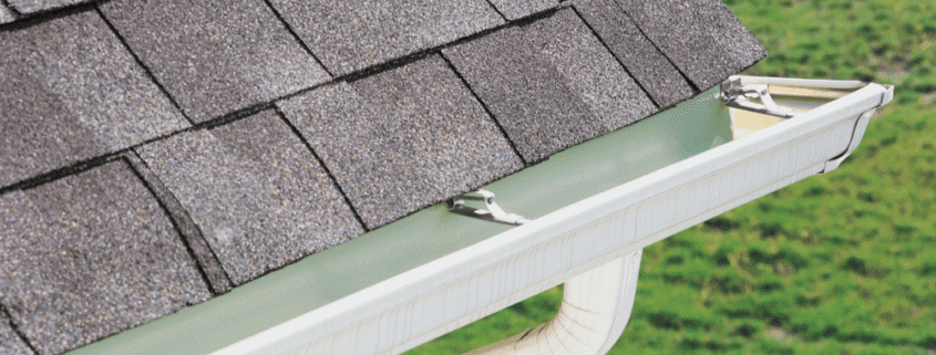 A drawing of gutter guards being installed on a house showcasing their benefits.