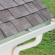 A drawing of gutter guards being installed on a house showcasing their benefits. 1