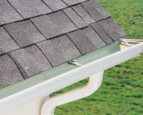 A drawing of gutter guards being installed on a house showcasing their benefits. 1
