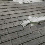 An image showing a damaged roof with missing shingles