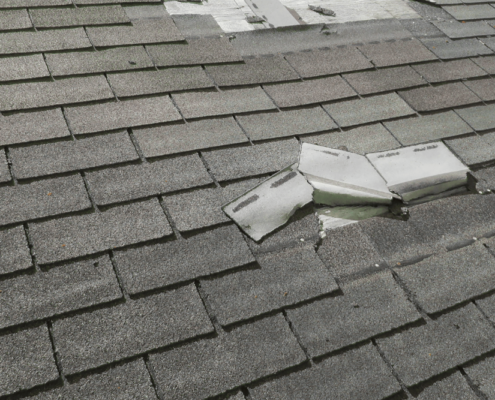 An image showing a damaged roof with missing shingles