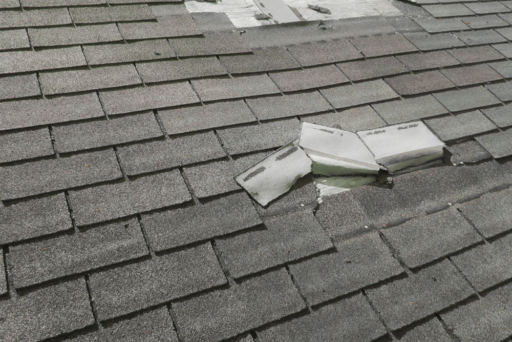 An image showing a damaged roof with missing shingles