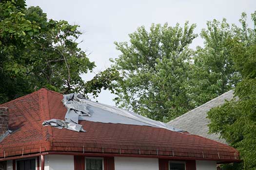 Story City tarp on roof