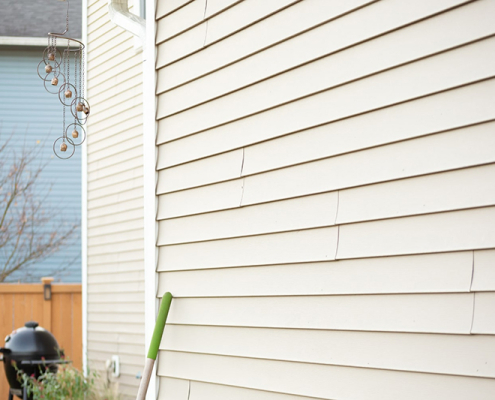 cream siding with wind chime