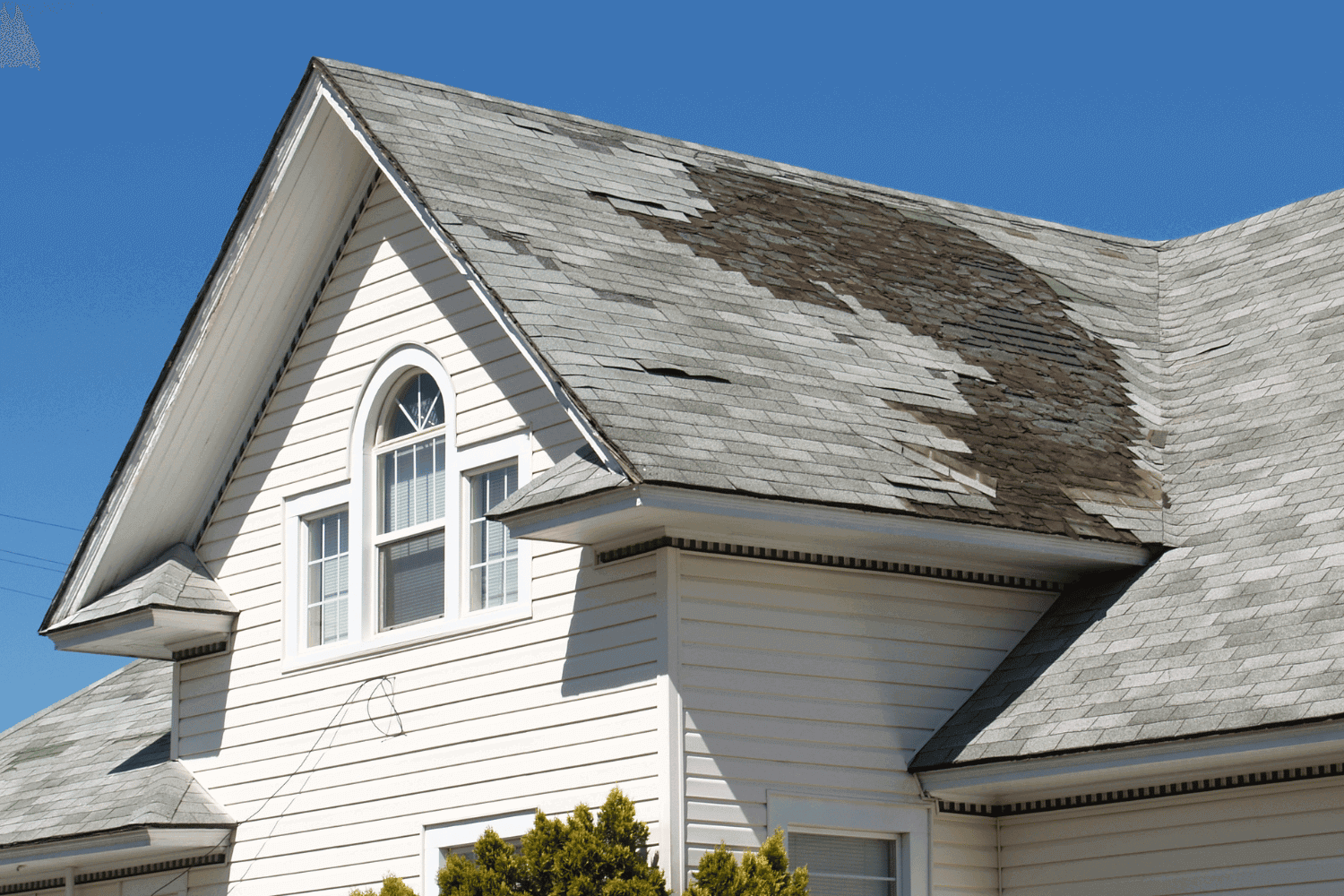 Signs indicating the need to replace your asphalt roof, including visible damage.