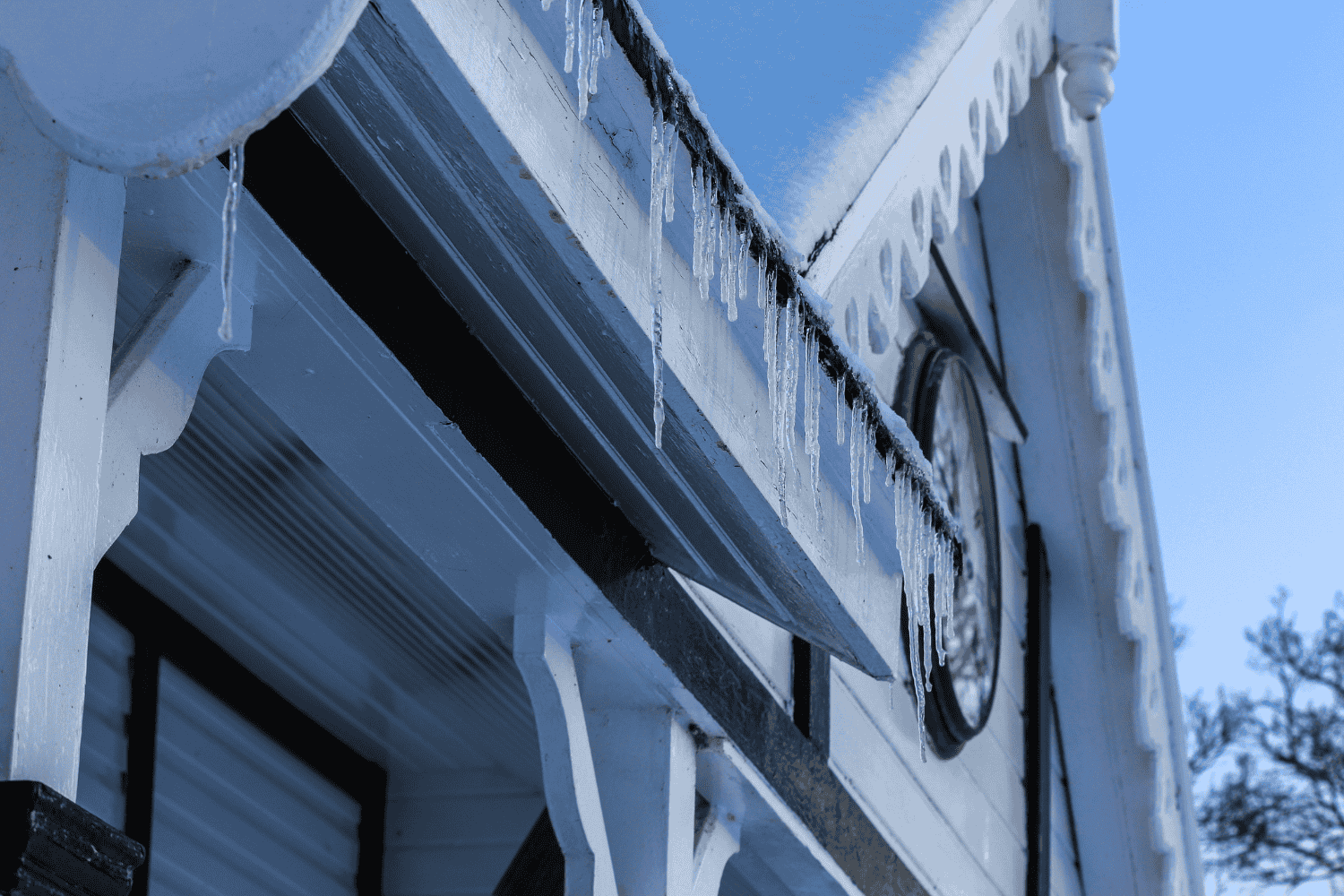 A leaky roof with ice dams forming, illustrating common winter roofing problems. A leaky roof with ice dams forming, illustrating common winter roofing problems.