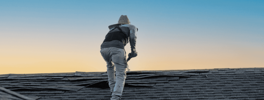 A professional roofing contractor inspecting a roof for damage.