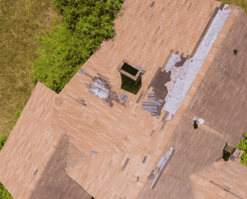 A roof inspection showing damaged shingles that have blown off.