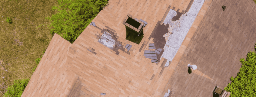 A roof inspection showing damaged shingles that have blown off.