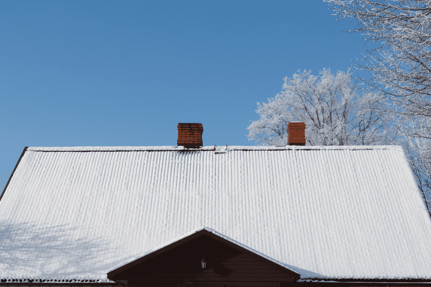 A roofer working on a roof during winter, showcasing the challenges of winter roofing. A roofer working on a roof during winter, showcasing the challenges of winter roofing.