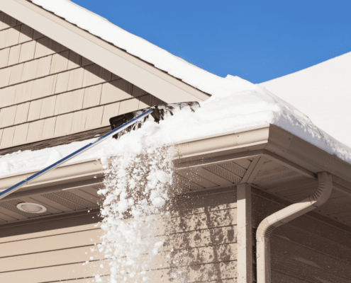 Different roofing materials affected by cold weather, including asphalt shingles and metal roofs.