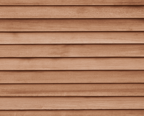 New wood siding boards ready to replace damaged ones.