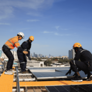 A collection of tools and materials needed for flat roof repair, including roofing cement and safety gear.
