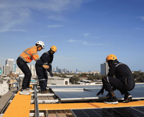 A collection of tools and materials needed for flat roof repair, including roofing cement and safety gear.